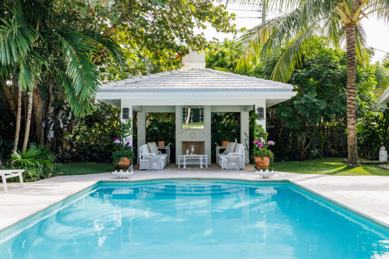 Backyard of a custom built RJS Builders Inc home, featuring a pool and cabana area.
